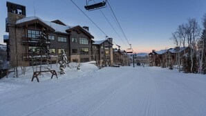 A ski resort with a large lodge, ski lift, and snow-covered landscape. - The Village at Empire - by Deer Valley (Park City)