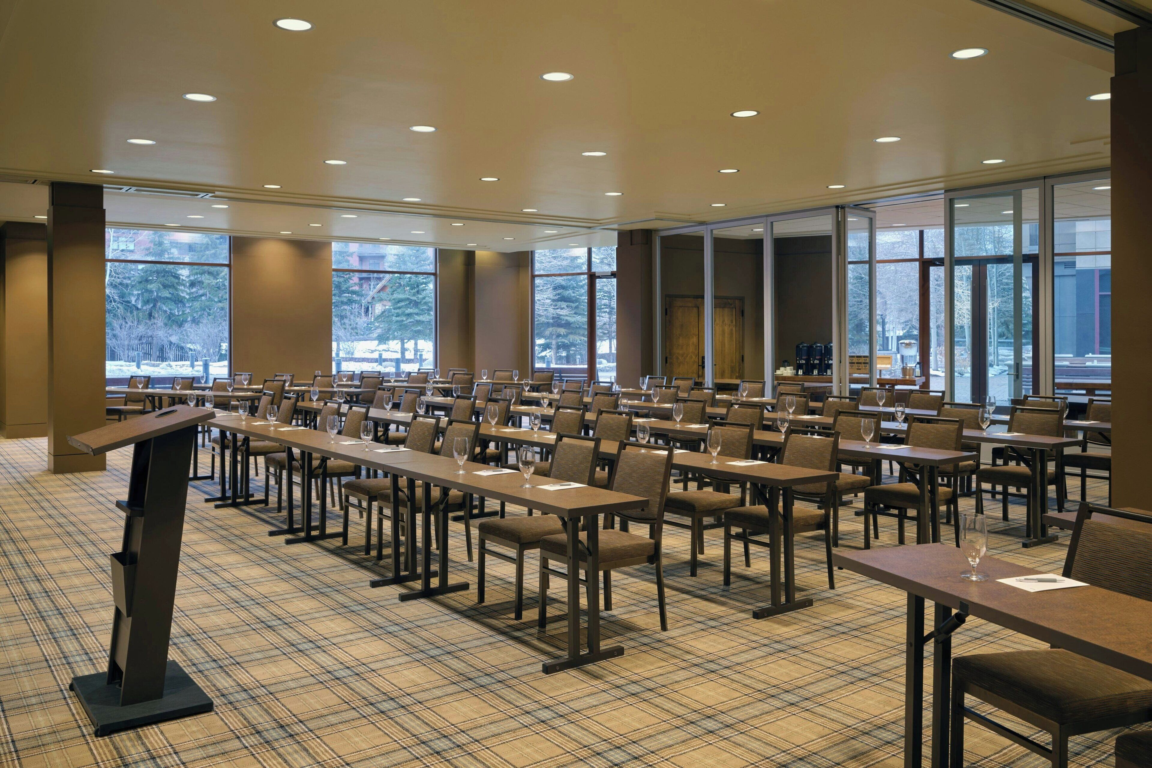 A conference room with tables and chairs arranged for a meeting.