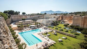 Relax by the pool surrounded by sun loungers and umbrellas, with breathtaking views of the mountains.