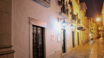 Stroll through the charming cobblestone streets of this historic neighborhood, home to Hotel da Rainha.