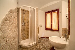 Shower, designer toiletries, bidet, towels