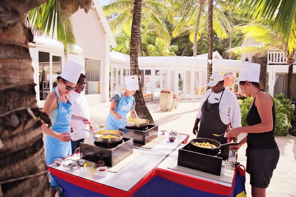 A group of chefs preparing food outdoors with a grill and cooking stations. - Tropical Attitude - Adults only (Trou d'Eau Douce)