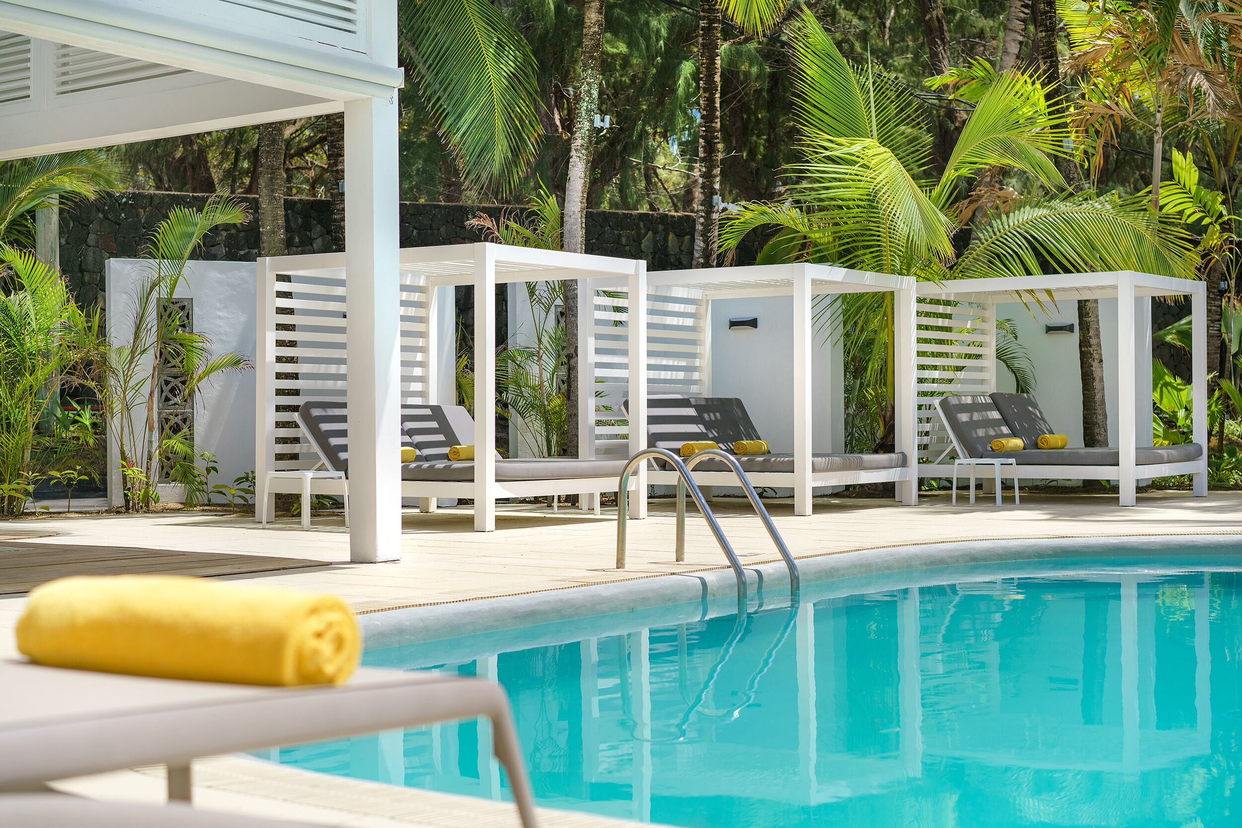 A poolside area with lounge chairs and a pool.
