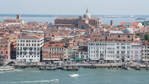 A historic cityscape with a prominent church and a waterfront promenade. - Hotel Paganelli (Venice)