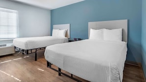 A hotel room with two beds, a window with blinds, and a ceiling light. - Extended Stay America Select Suites - Beaumont (Beaumont)