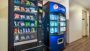 A vending machine with snacks and a Pepsi machine in a hallway. - Extended Stay America Select Suites - Pensacola - Northwest (Pensacola)