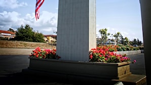 A sign with "Sands by the Sea" and an American flag, with a welcome message.