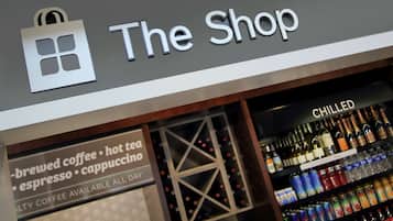 A shop sign with a logo and the text "The Shop".