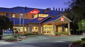 A Hilton Garden Inn with a modern design, featuring a prominent entrance and a well-lit facade. - Hilton Garden Inn Sonoma County Airport (Santa Rosa)