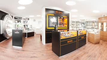 A luxury watch store with multiple display cases and branded sections.