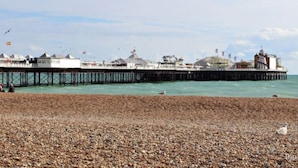 A pier extending into the sea with a building at the end. - The Beach Hotel (Brighton)