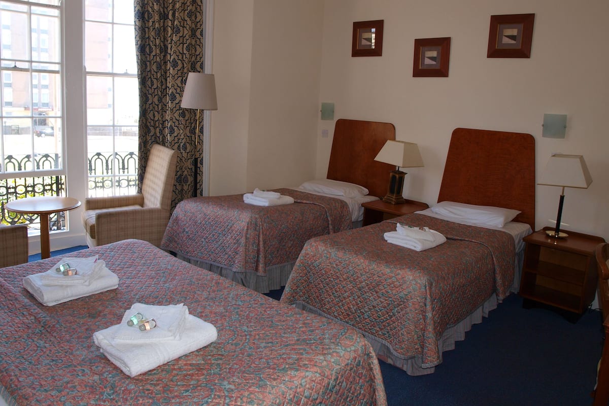 Family Room | Desk, blackout curtains, iron/ironing board, bed sheets