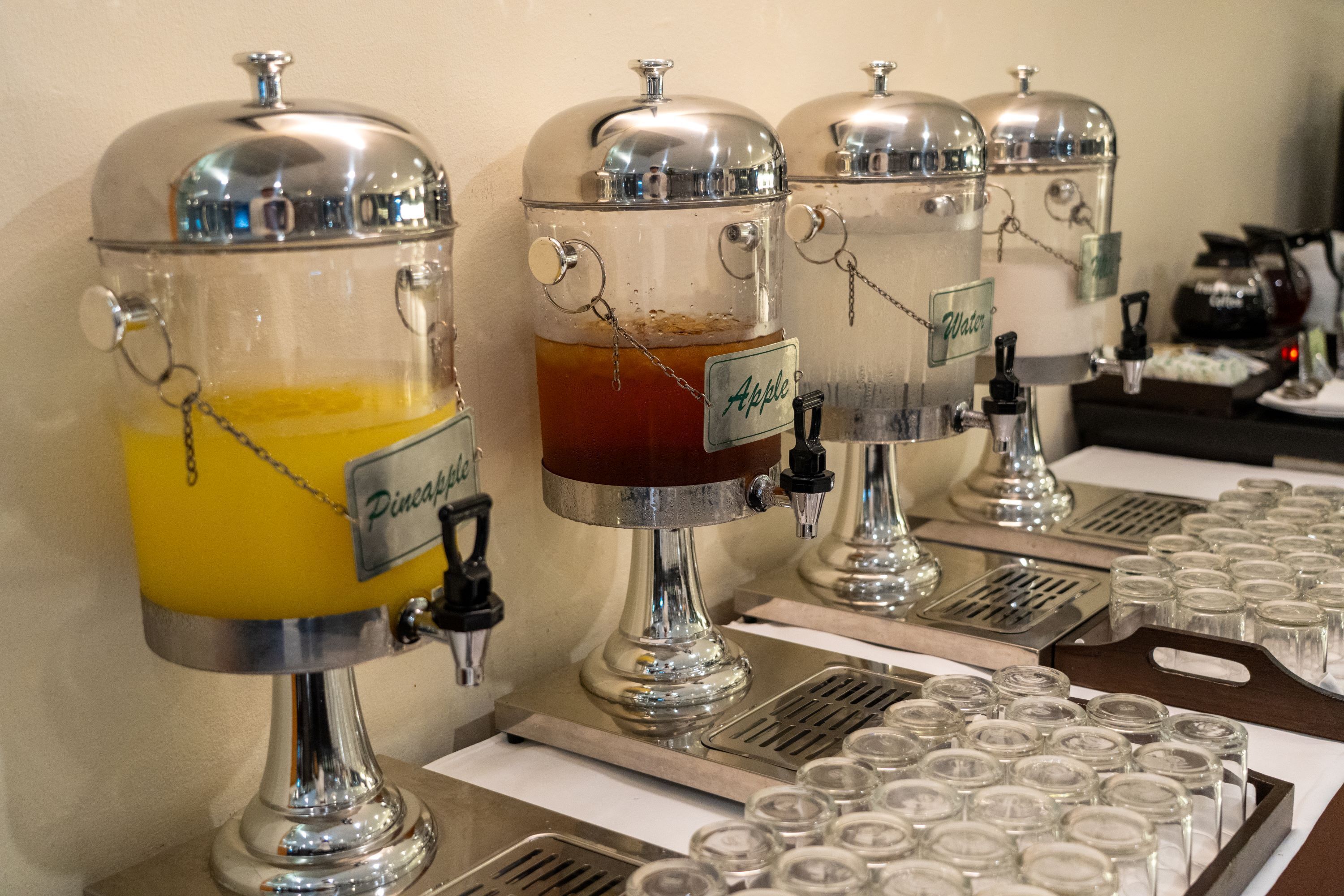 A beverage station with dispensers labeled "Pineapple" and "Apple."