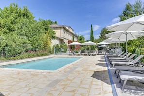 Outdoor pool, open 10:00 AM to 8:00 PM, pool umbrellas, pool loungers