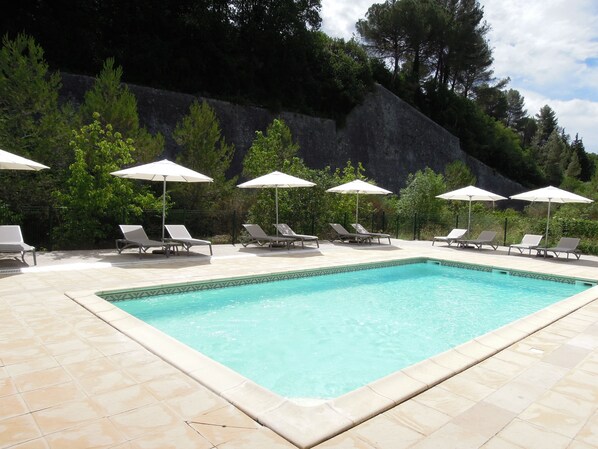Outdoor pool, open 10:00 AM to 8:00 PM, pool umbrellas, pool loungers