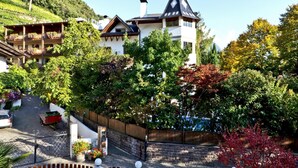 A hotel with a traditional European architectural style, featuring a prominent tower and multiple balconies. - Sittnerhof (Merano)