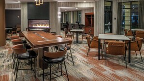 A modern conference room with a long table, chairs, a fireplace, and large windows. - Courtyard by Marriott Carson City (Carson City)