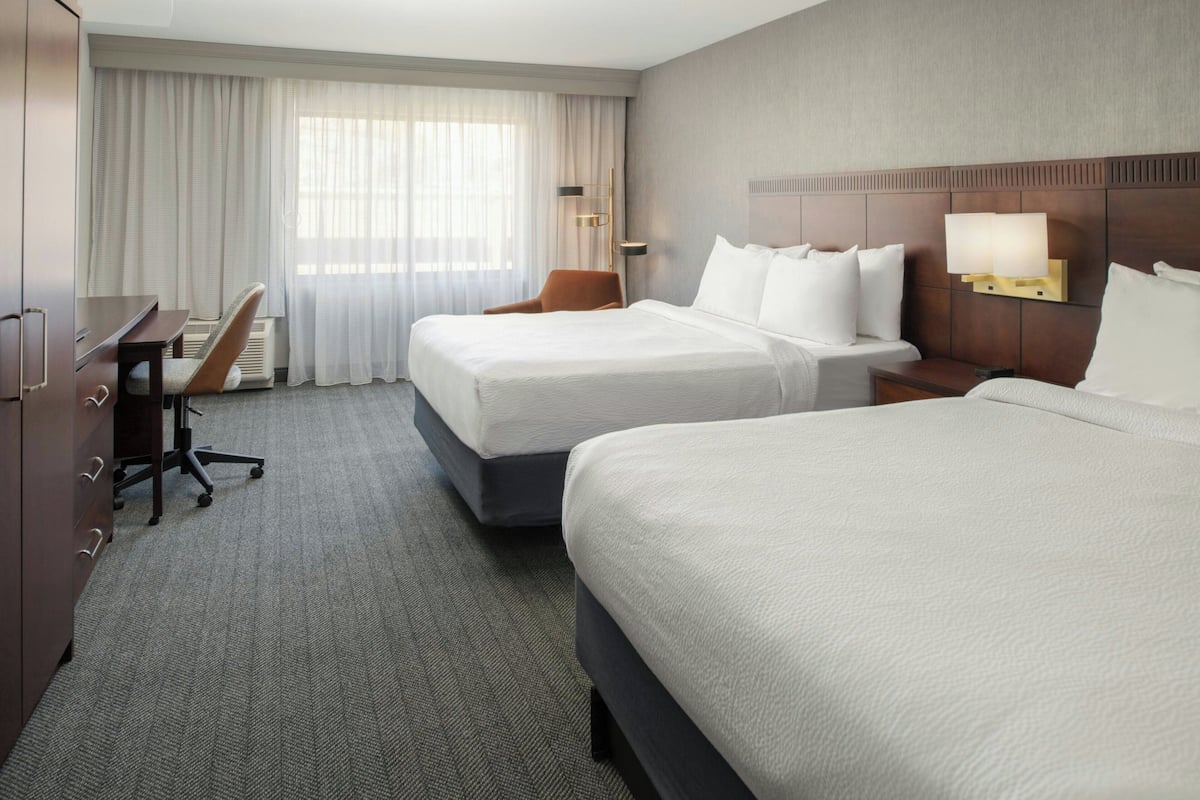 Premium bedding, desk, laptop workspace, blackout drapes