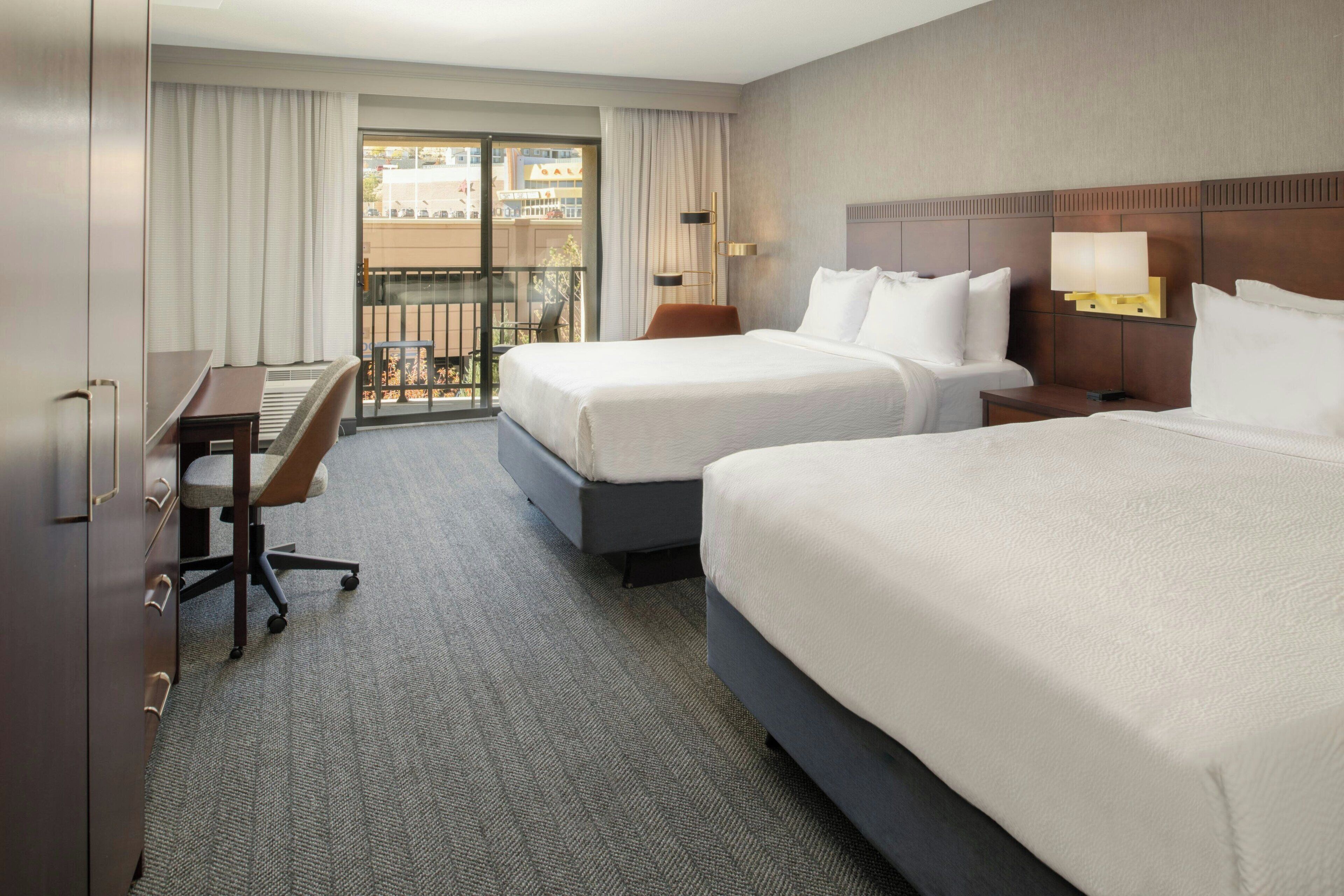 Premium bedding, desk, laptop workspace, blackout drapes