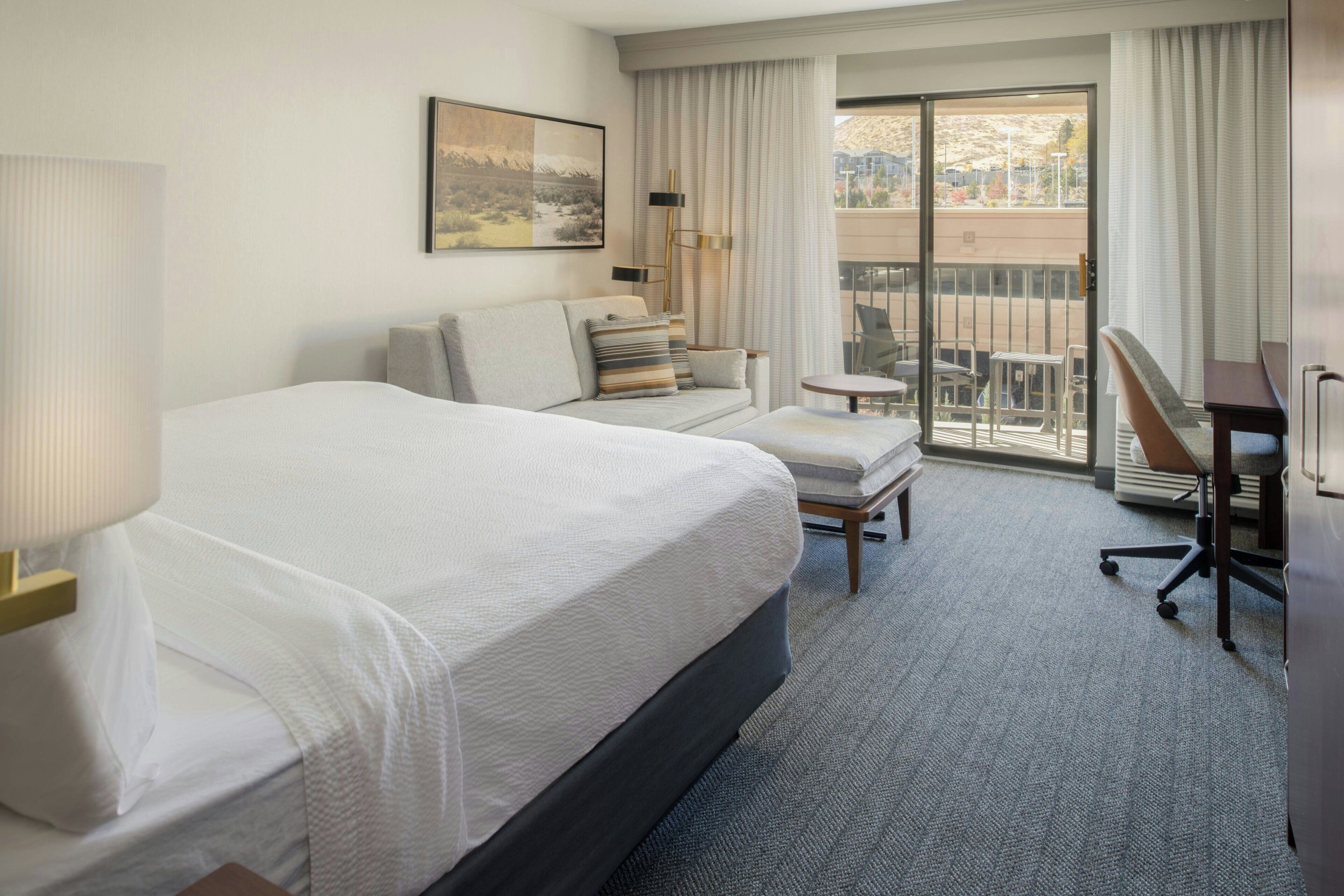 Premium bedding, desk, laptop workspace, blackout drapes