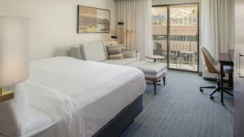 Premium bedding, desk, laptop workspace, blackout drapes