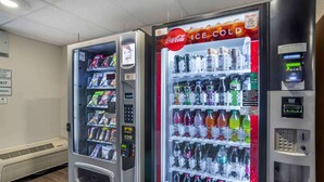 Two vending machines with a variety of snacks and beverages, including Coca-Cola Ice Cold. - Extended Stay America Select Suites - Tallahassee - East (Tallahassee)