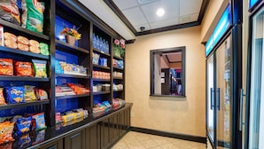 A snack bar with shelves stocked with various snacks and beverages. - Hampton Inn & Suites Waco-South (Waco)