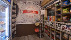 A bakery section with a 'Treats' sign, shelves stocked with snacks, and a 'Welcome to the Bakersfield' sign.