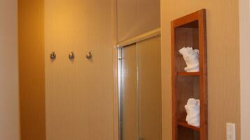 A bathroom with a toilet, a shower, and a towel rack.