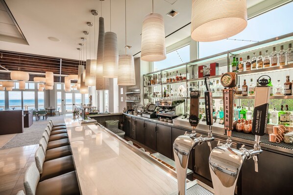 A bar area with seating, a bar counter, and a view of the sea. - InterContinental the Clement Monterey by IHG (Monterey)