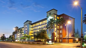 A multi-story hotel with a modern design, featuring balconies and a central courtyard with palm trees. - Bluegreen Vacations Orlando's Sunshine, Ascend Collection Resort (Orlando)