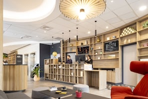 Welcome to our reception area, where friendly staff are always available to assist you. Enjoy the comfortable seating and browse the latest information on our digital screen.