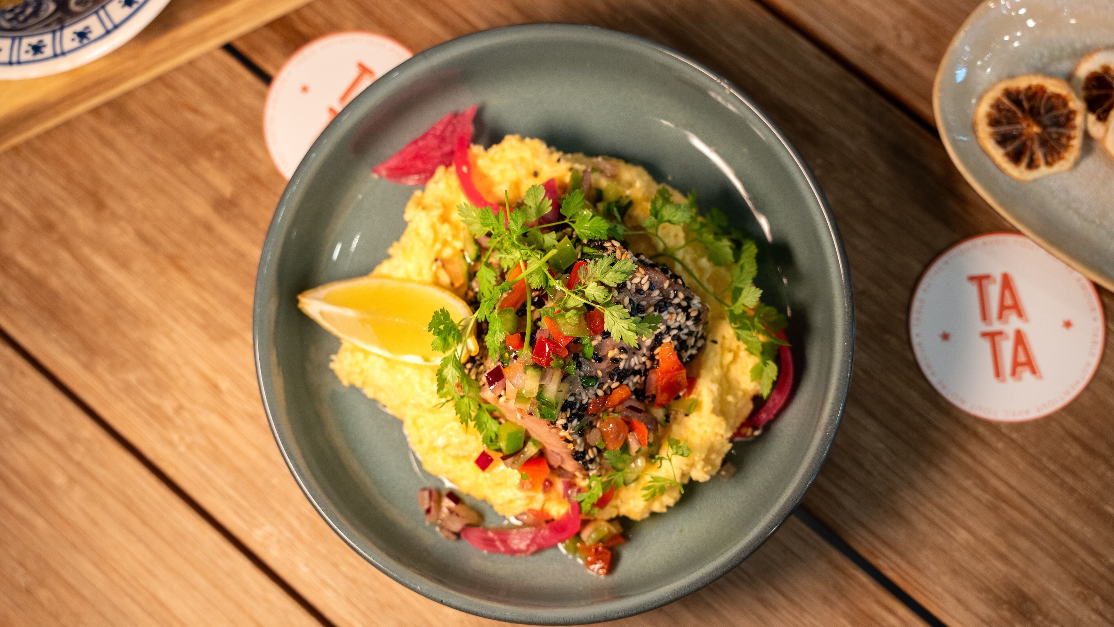 A plate of food with a lemon wedge and parsley garnish.