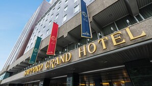 The exterior of the Sapporo Grand Hotel with a modern architectural design, featuring large windows and a prominent hotel sign. - Sapporo Grand Hotel (Sapporo)