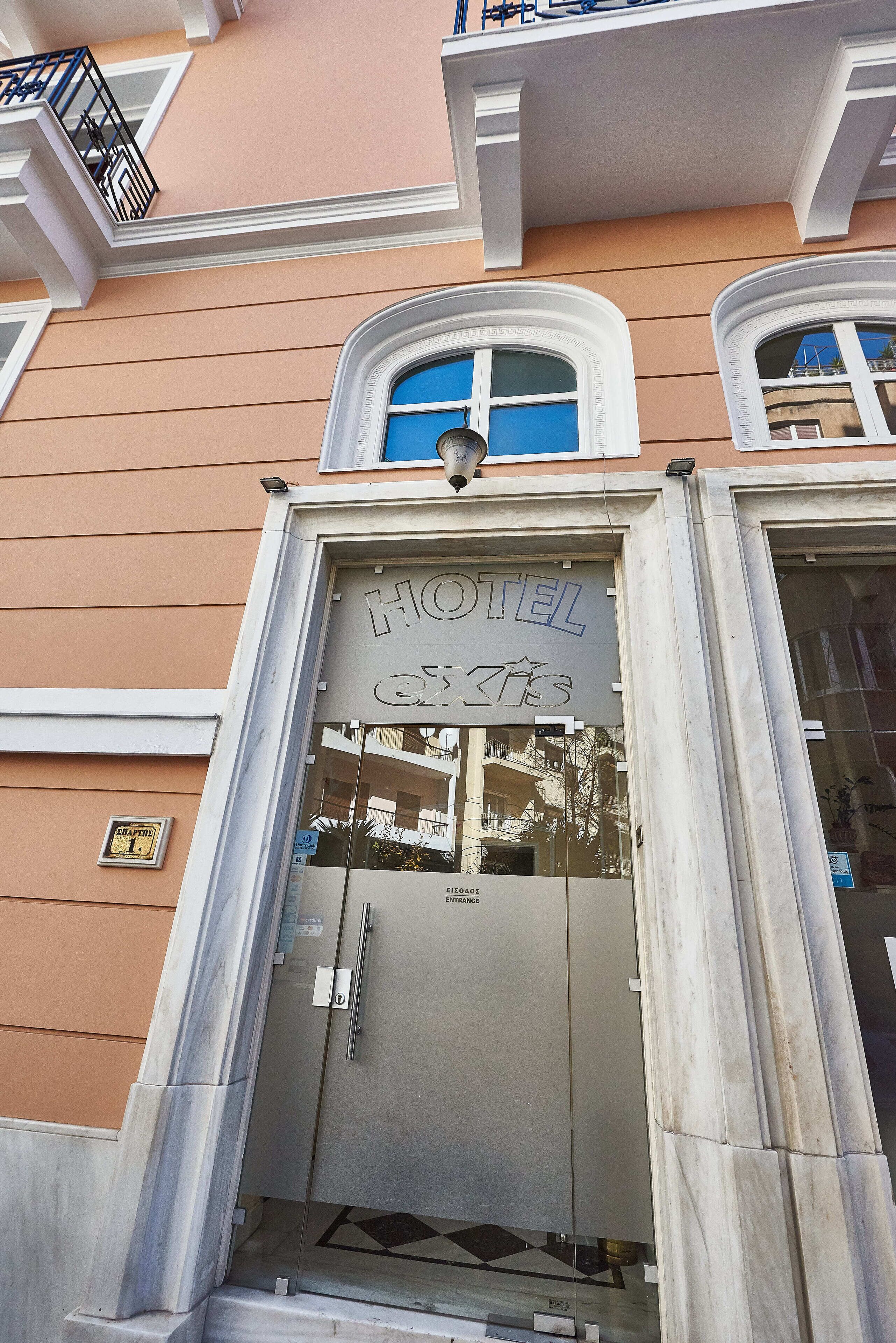 A hotel entrance with a sign reading "HOTEL EXCITES" and a "CHAPEL 1" sign below.