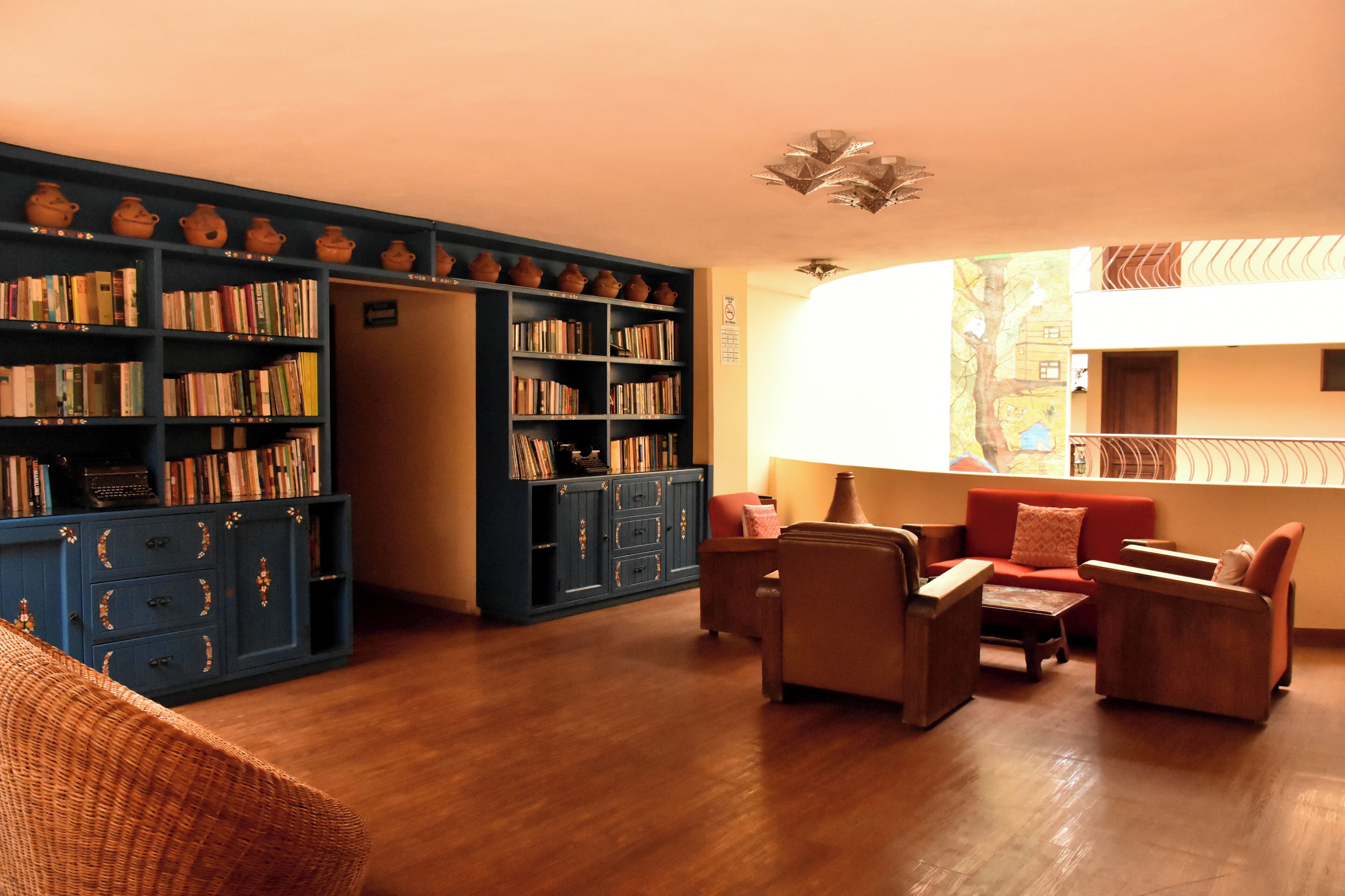 A cozy living room with a fireplace, a bookshelf, and a sofa.