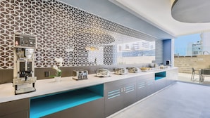 A modern kitchen with a geometric backsplash, a coffee machine, and a breakfast bar. - One Acapulco Costera (Acapulco)