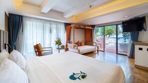 A hotel room with a large bed, a sofa, a TV, and a balcony with a view. - Baan Samui Resort (Koh Samui)