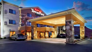 A Marriott TownePlace Suites hotel with a stone facade, large entrance canopy, and multiple parking spaces.