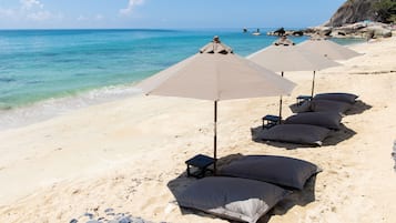 On the beach, sun-loungers, beach umbrellas, beach towels