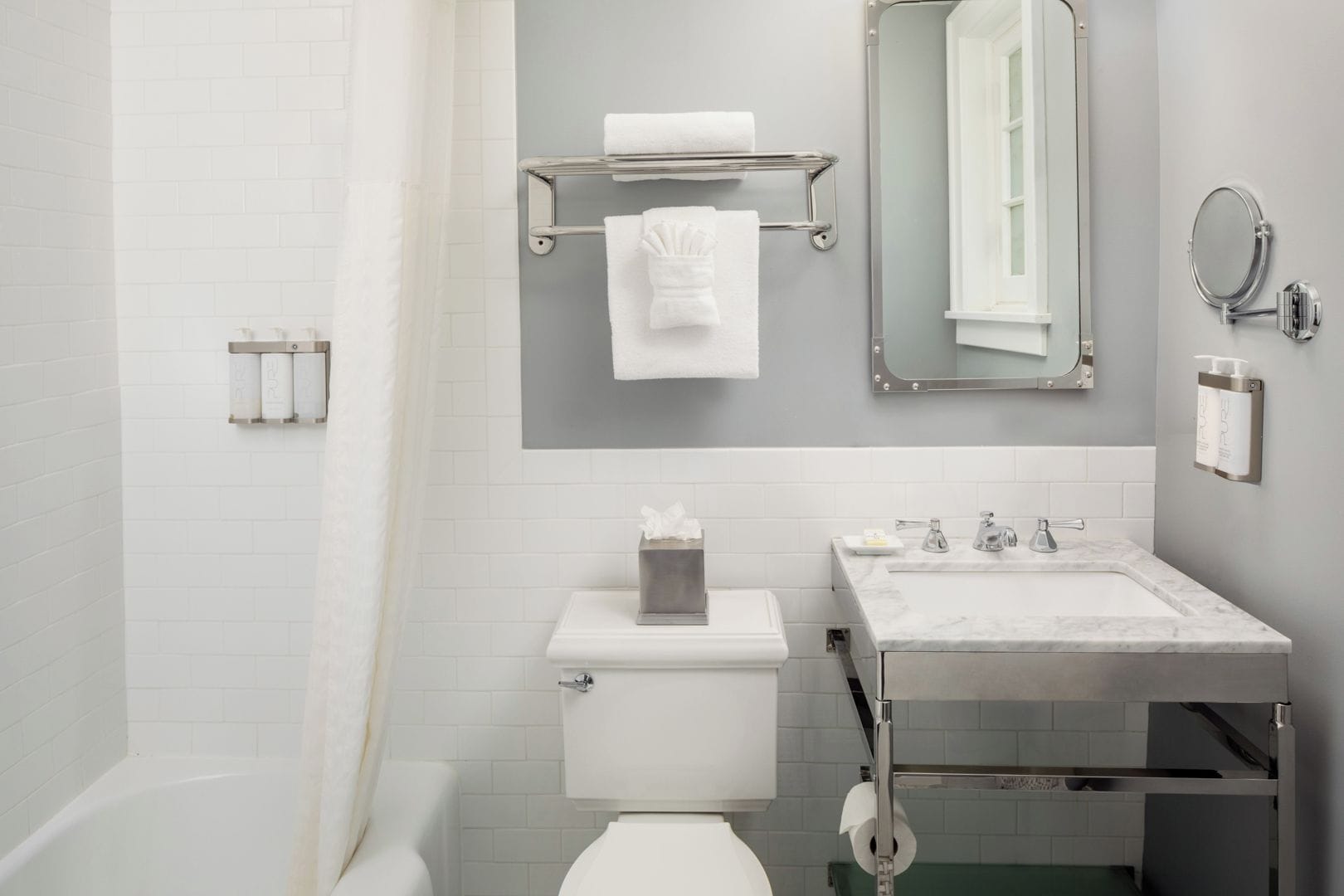 A modern bathroom with a toilet, sink, and shower area.