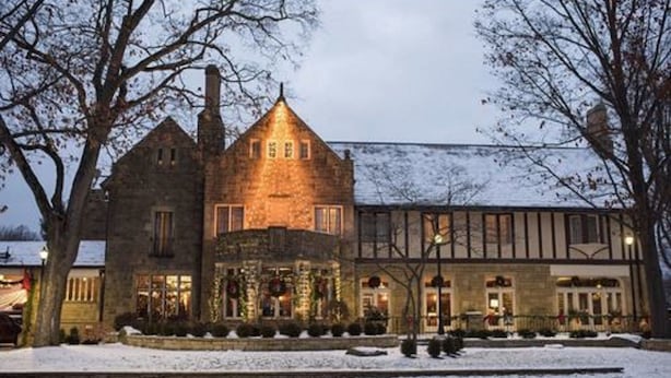 A large stone building with a prominent central tower and multiple windows, surrounded by snow. - Granville Inn (Granville)