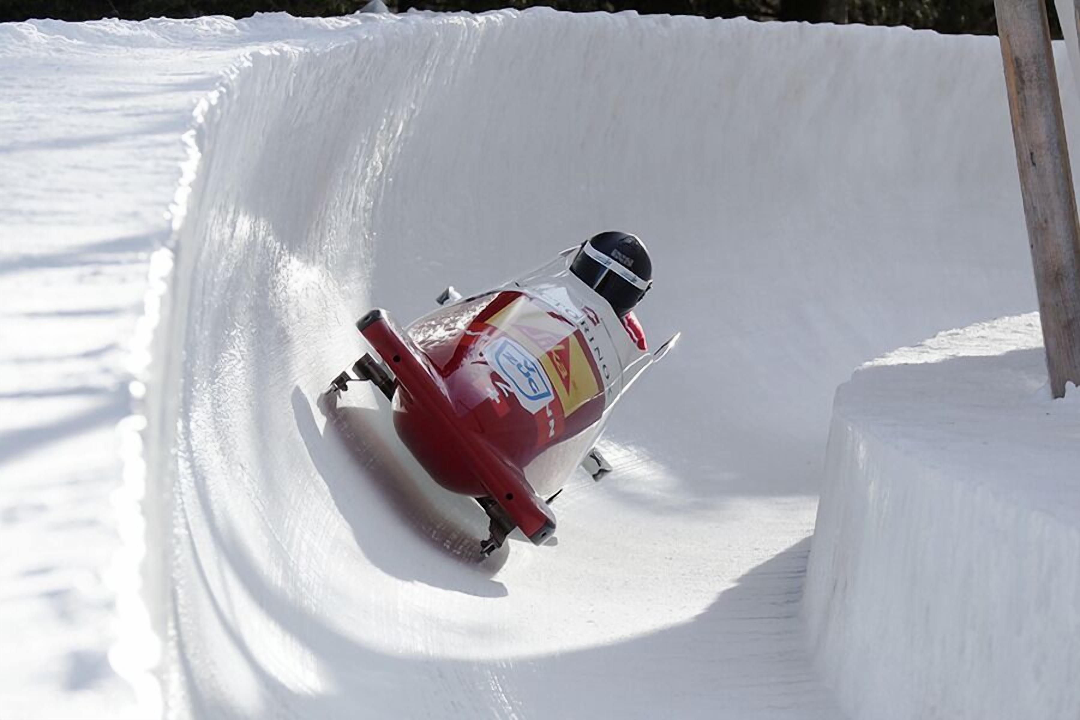 A person skiing down a snow-covered slope.