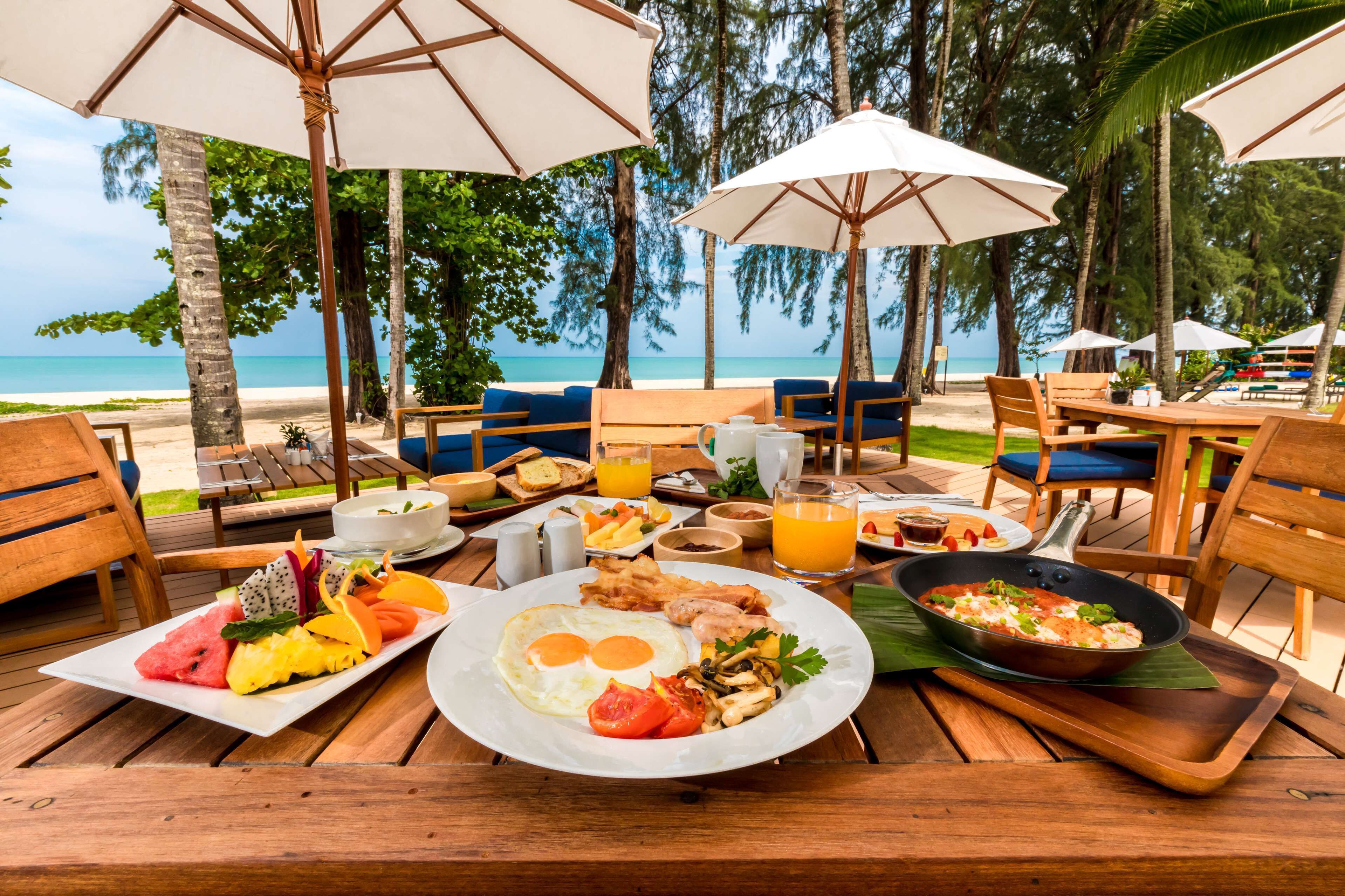 A breakfast setup with a view of the beach and ocean.