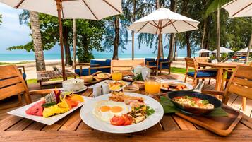 A breakfast setup with a view of the beach and ocean.