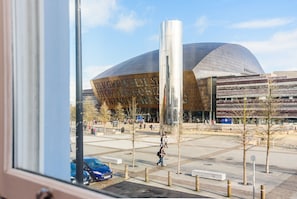 A modern building with a curved facade and a large reflective column. - Jolyon's Boutique Hotel (Cardiff)