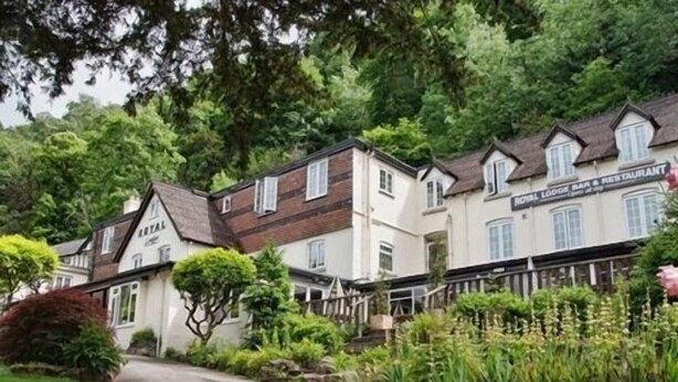 A pathway leading to a row of buildings with a sign reading "ROYAL LOCH BAR & RESTAURANT". - The Royal Lodge (Ross-on-Wye)