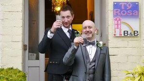 Two men in formal attire outside a building with a sign that reads "Tý Rosa B&B". - Tyrosa Rooms   (Cardiff)