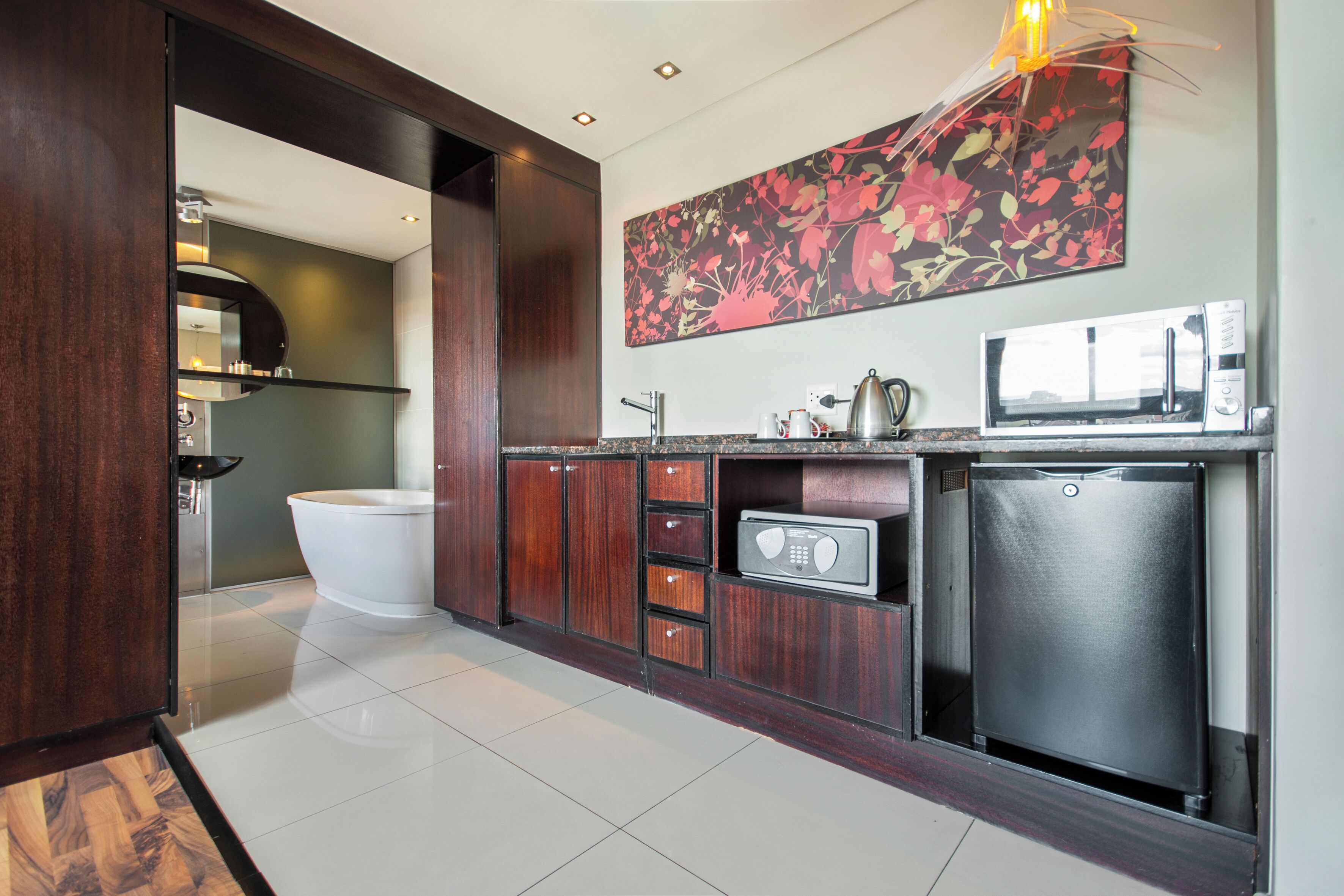 A modern kitchen with a built-in microwave, a refrigerator, and a sink.