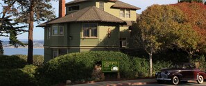 A historic building with a sign for 'Jabberwock Inn' and a vintage car parked in front. - Jabberwock Inn (Monterey)